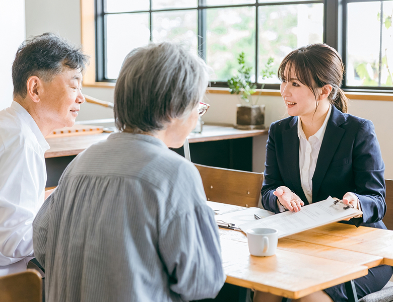 夫婦に説明する営業マン